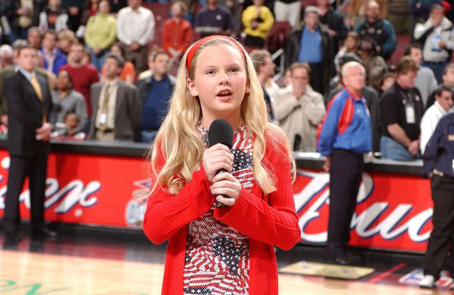 Jesse D. Garrabrant/NBAE via Getty Taylor Swift singing the national anthem prior before a basketball game in April 2002