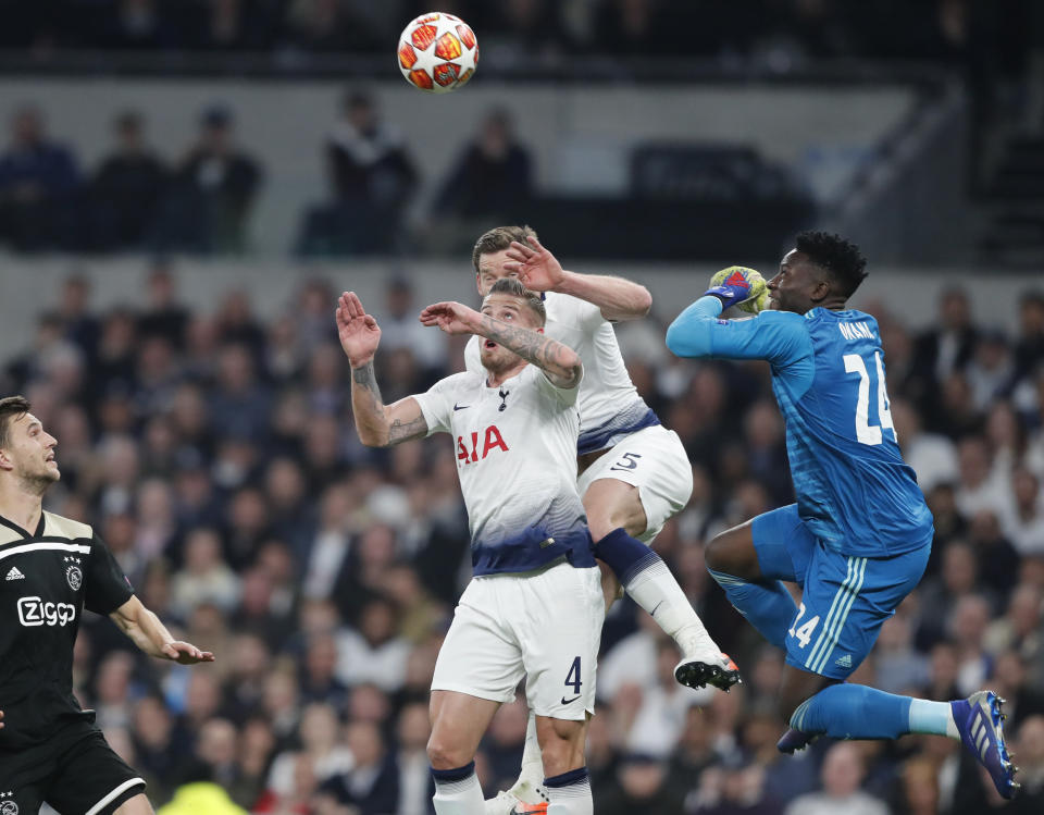 Tottenham's Toby Alderweireld, center left, and Tottenham's Jan Vertonghen, center rear, and Ajax goalkeeper Andre Onana, right, jump for the ball during the Champions League semifinal first leg soccer match between Tottenham Hotspur and Ajax at the Tottenham Hotspur stadium in London, Tuesday, April 30, 2019. (AP Photo/Frank Augstein)