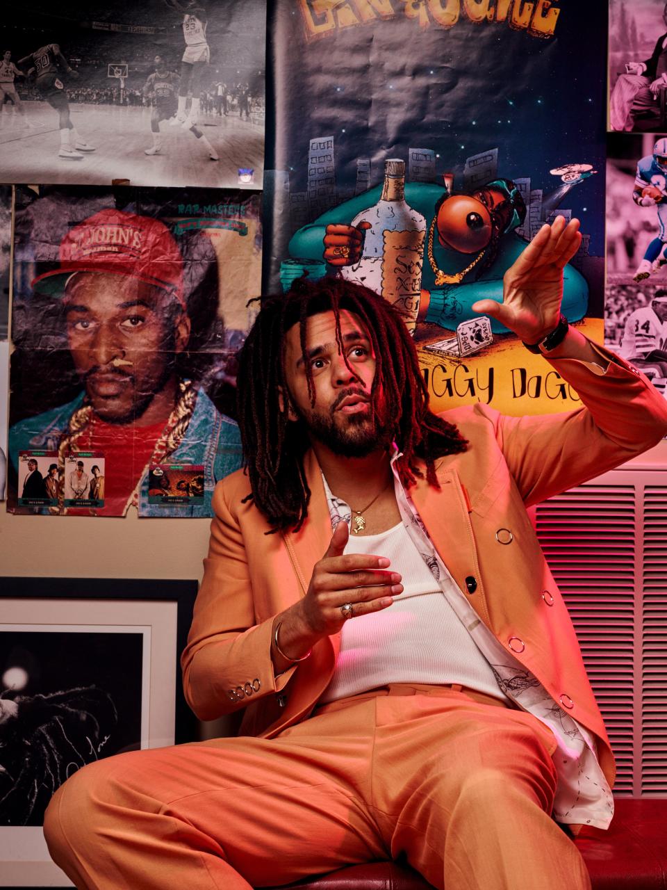 J. Cole in the poster-lined basement of the Sheltuh, his Raleigh, North Carolina, studio.