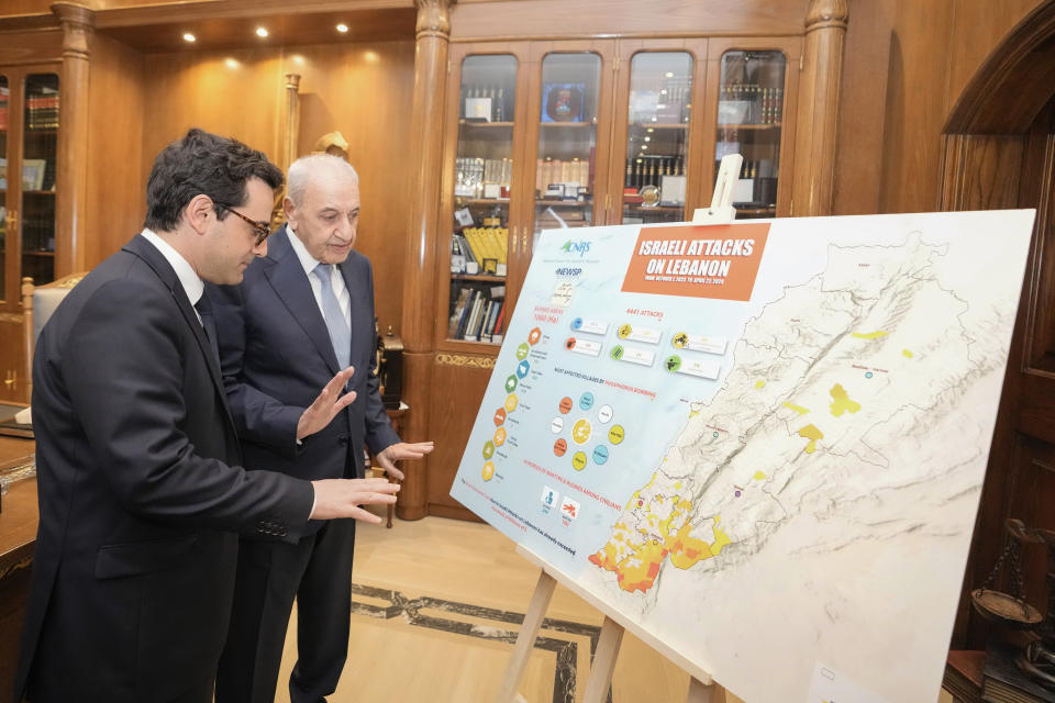 Lebanese Parliament Speaker Nabih Berri, right, shows a map that details Israel's strikes on Lebanon since Oct. 7, to visiting French Foreign Minister Stephane Sejourne during their meeting, in Beirut, Lebanon, Sunday, April 28, 2024. (AP Photo/Hassan Ammar)