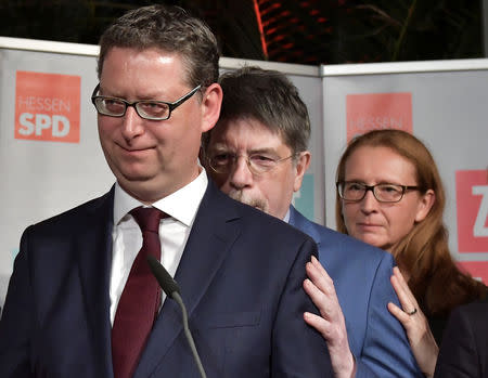 Social Democratic Party (SPD) top candidate Thorsten Schaefer-Guembel, SPD members Gernot Grumbach and Gisela Stang react after first exit polls following the Hesse state election in Wiesbaden, Germany, October 28, 2018. REUTERS/Thorsten Wagner