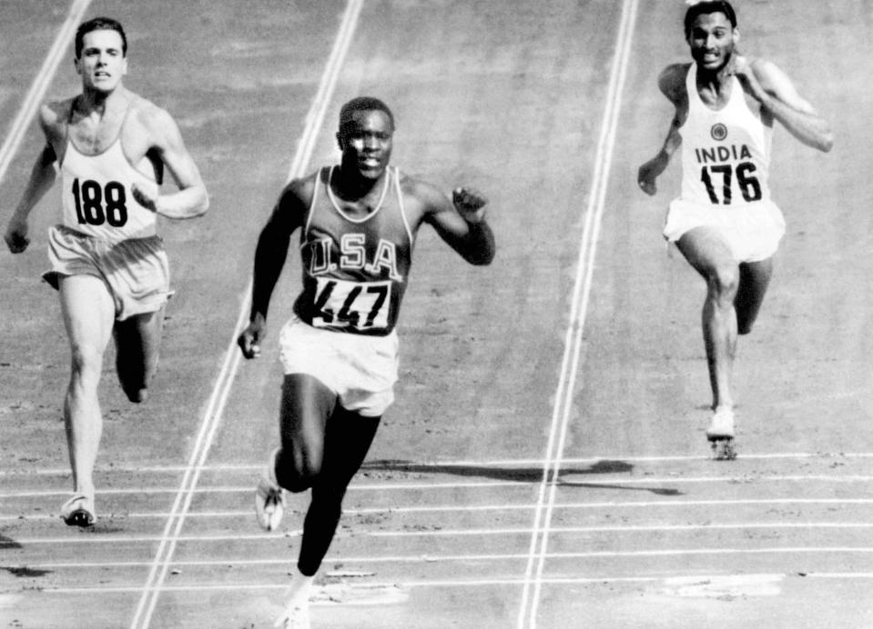 FILE - In this Sept. 5, 1960, file photo, Rafer Johnson of the United States, center, finishers the fourth heat of the decathlon 100 meter dash at the Olympics in Rome, Italy. Eef Kamerbeek of Netherlands is at left, and Gurbachan Singh Randhawa of India is at right. Rafer Johnson, who won the decathlon at the 1960 Rome Olympics and helped subdue Robert F. Kennedy's assassin in 1968, died Wednesday, Dec. 2, 2020. He was 86. He died at his home in the Sherman Oaks section of Los Angeles, according to family friend Michael Roth. (AP Photo/Olympic Pool, File)