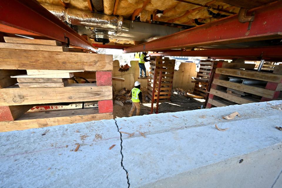 Workers work under 4 William Circle as it is raised above its foundation due to the content of pyrrhotite, a mineral that causes foundation crumbling.