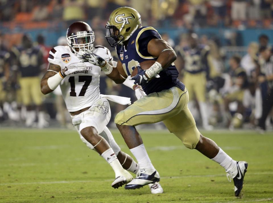 Georgia Tech running back Charles Perkins (21) runs as Mississippi State defensive back Deontay Evans (17) defends in the first half of the Orange Bowl NCAA college football game, Wednesday, Dec. 31, 2014, in Miami Gardens, Fla. (AP Photo/Wilfredo Lee)