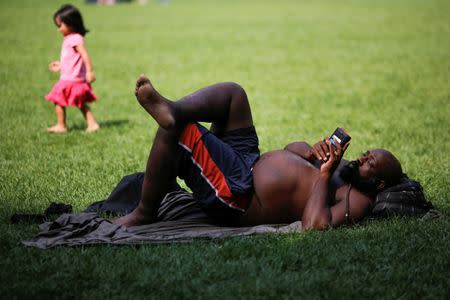 A man sunbathes on a hot summer day in Bryant Park, Manhattan, New York, U.S., July 1, 2018. REUTERS/Eduardo Munoz