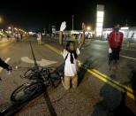 <p>A man holds his hands up in the street after a standoff with police Monday, Aug. 18, 2014, during a protest for Michael Brown, who was killed by a police officer Aug. 9 in Ferguson, Mo. (Charlie Riedel/AP) </p>