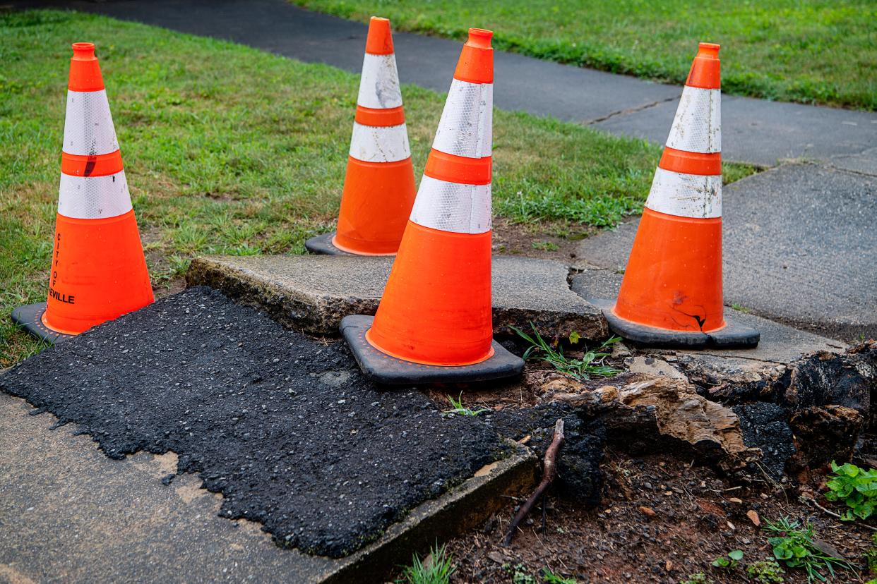 A damaged portion of the sidewalk along Vermont Ave. in Asheville July 20, 2023.