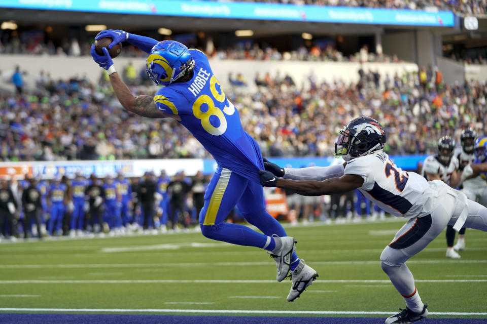 Los Angeles Rams tight end Tyler Higbee scores past Denver Broncos cornerback Damarri Mathis during the first half of an NFL football game between the Los Angeles Rams and the Denver Broncos on Sunday, Dec. 25, 2022, in Inglewood, Calif. (AP Photo/Jae C. Hong)