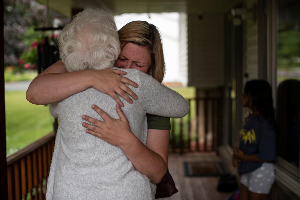 Kristine Courts, wife of Detroit Police officer Loren Courts, is comforted by her grandmother Caroline Sandel on July 8, 2022.