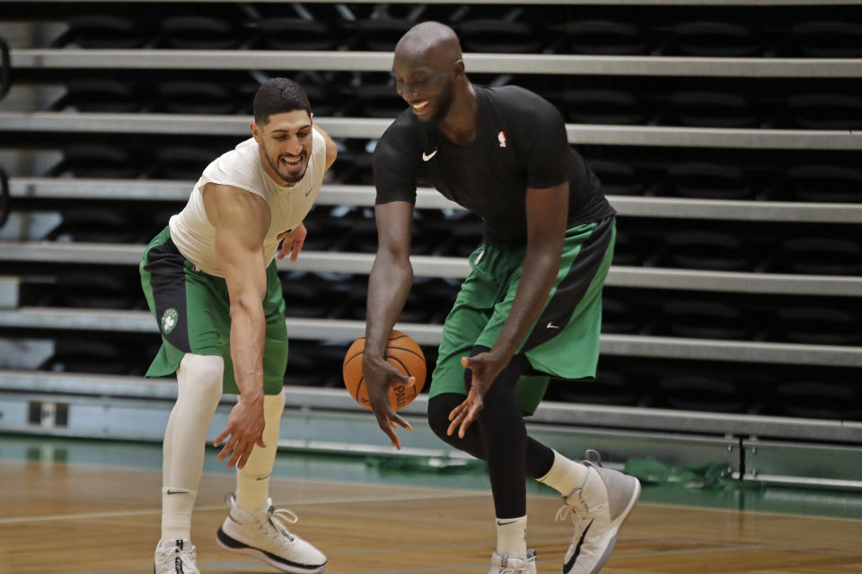 Boston Celtics centers Enes Kanter, left, and Tacko Fall play one-on-one during the NBA basketball team's training camp, Tuesday, Oct. 1, 2019 in Boston. (AP Photo/Elise Amendola)