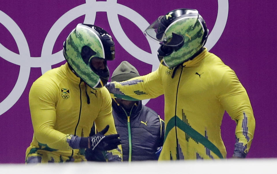 The team from Jamaica JAM-1, piloted by Winston Watts and brakeman Marvin Dixon, prepare to start their first run during the men's two-man bobsled competition at the 2014 Winter Olympics, Sunday, Feb. 16, 2014, in Krasnaya Polyana, Russia. (AP Photo/Dita Alangkara)