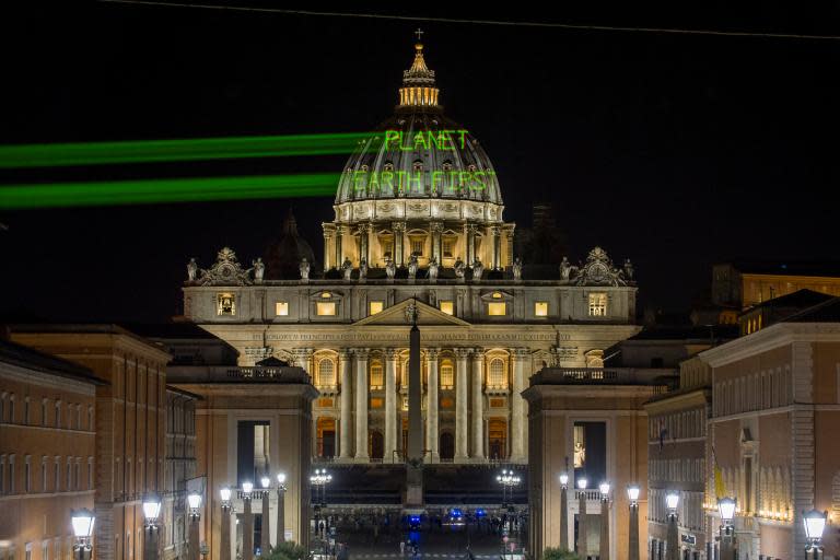 Greenpeace beams message for Donald Trump onto Vatican during visit