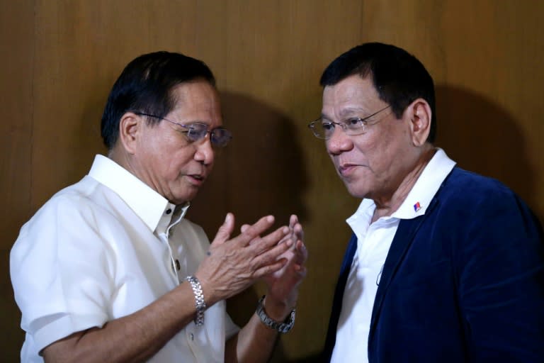 Philippines President Rodrigo Duterte (R) listens to his peace advisor Jesus Dureza during a meeting at Malacanang Palace in Manila