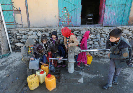 Afghan children collect water from a public water pump in Kabul, Afghanistan February 20, 2017. Picture taken February 20, 2017. REUTERS/Omar Sobhani