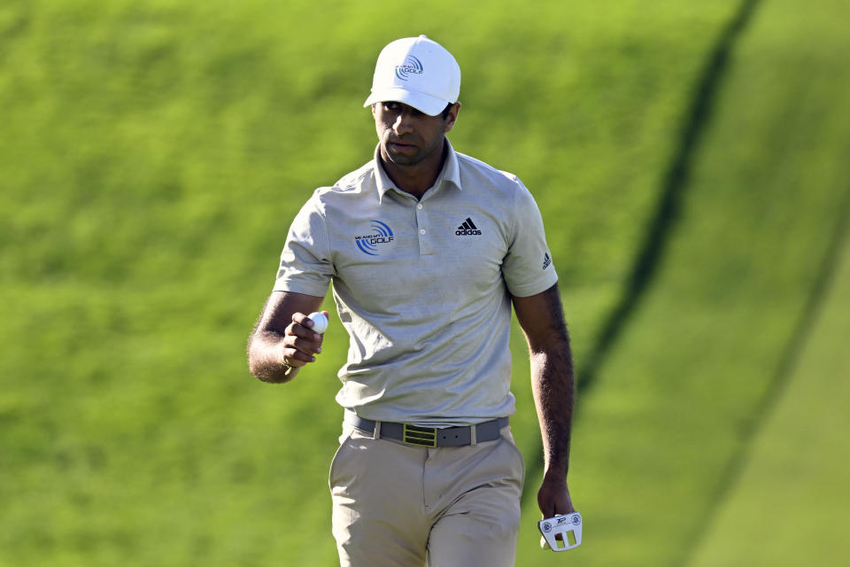 Aaron Rai holds up the ball after hitting a birdie on the 13th hole of the South Course during the third round of the Farmers Insurance Open golf tournament, Friday Jan. 28, 2022, in San Diego. (AP Photo/Denis Poroy)