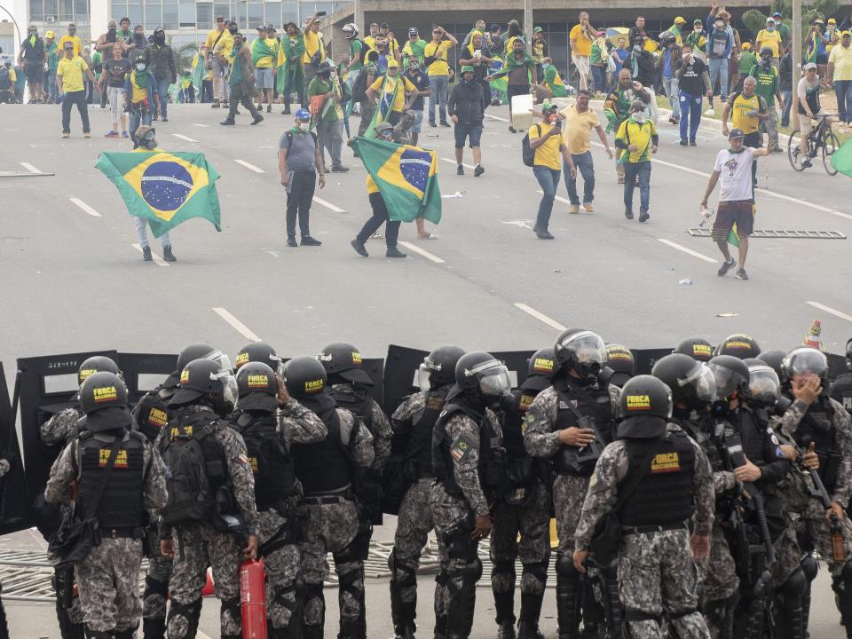 Supporters of Brazil's former President Jair Bolsonaro clash with security forces as they raid the National Congress in Brasilia, Brazil, on January 8, 2023.