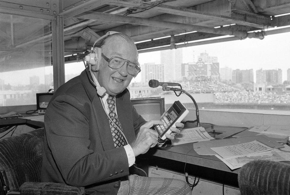 Chicago Cubs sportscaster Jack Brickhouse, a veteran of 32 years and some 4,726 baseball telecasts, gets a little help from a pocket calculator in radio booth at Chicago's Wrigley Field on Aug. 21, 1979. Brickhouse says baseball is a game of records where the fans delight in 'unbroken' records.