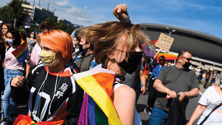 Teen dancing with rainbow flag