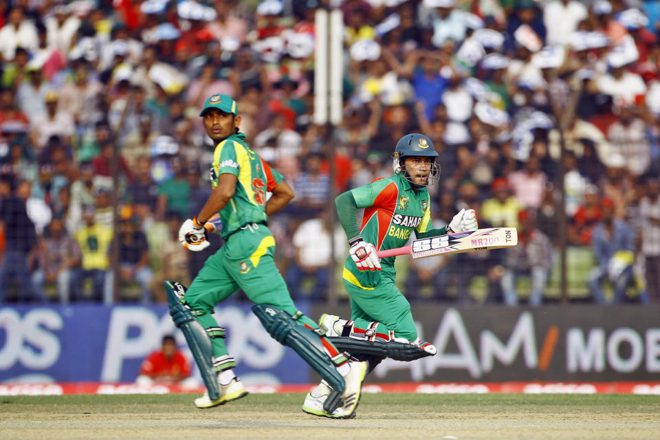 Bangladeshi Mushfiqur Rahim, right, and Anamul Haque run between the wickets during the Asia Cup one-day international cricket tournament against India in Fatullah, near Dhaka, Bangladesh, Wednesday, Feb. 26, 2014. (AP Photo/A.M. Ahad)