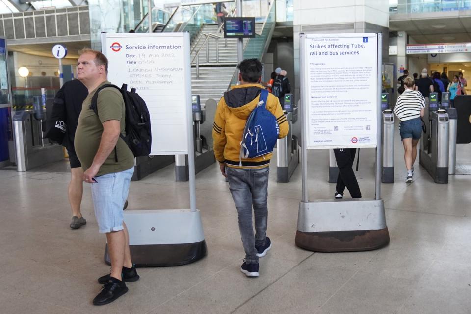 Passengers walk past information notices at Stratford train station in east London (Stefan Rousseau/PA) (PA Wire)