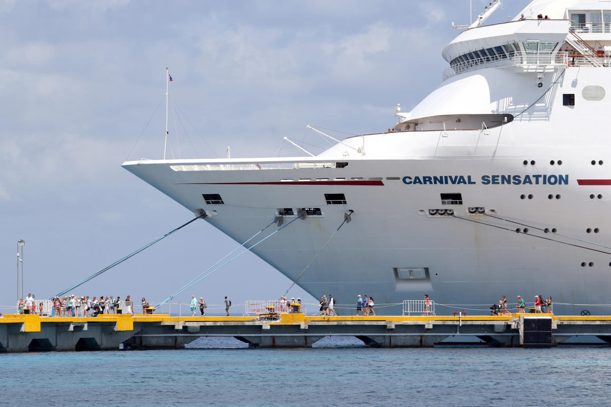 Passengers of the Carnival Sensation, operated by Carnival Cruise Line, are seen next to the docked cruise ship after being diverted from Cuba following the Trump administration's ban on travel to the Caribbean Island, in Cozumel, Mexico June 6, 2019. REUTERS/Jorge Delgado