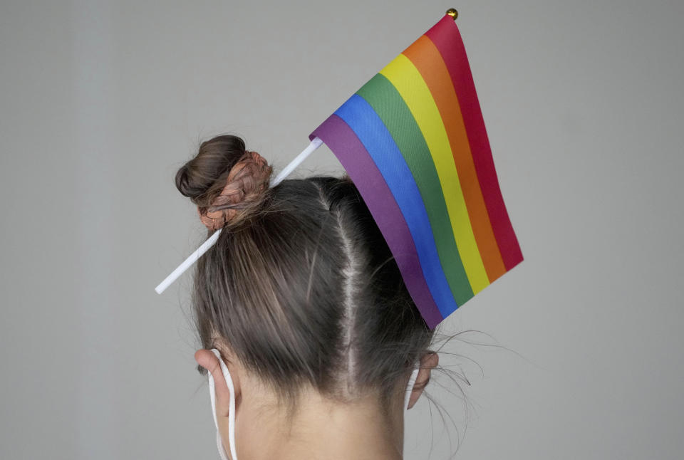 A woman wears a LGBT pride flag in her hair outside the stadium before the Euro 2020 soccer championship group F match between Germany and Hungary at the Allianz Arena in Munich, Germany,Wednesday, June 23, 2021. (AP Photo/Matthias Schrader)