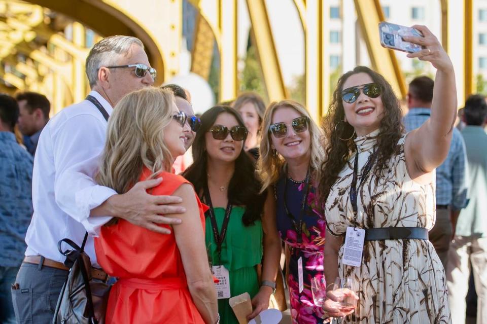 Elk Grove Mayor Bobbie Singh-Allen takes a selfie with attendees at the Tower Bridge Dinner on the Tower Bridge between Sacramento and West Sacramento on Sunday.