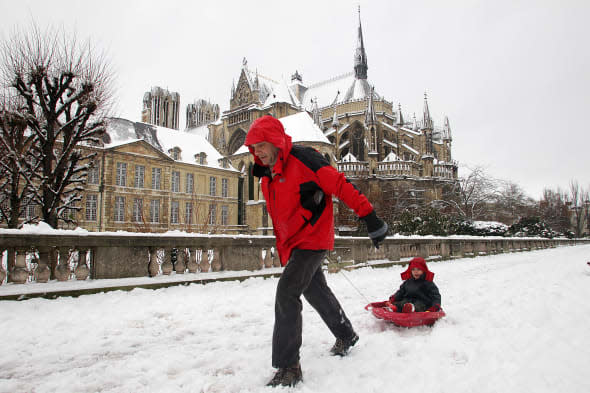 A father pulls a sledge with his child o