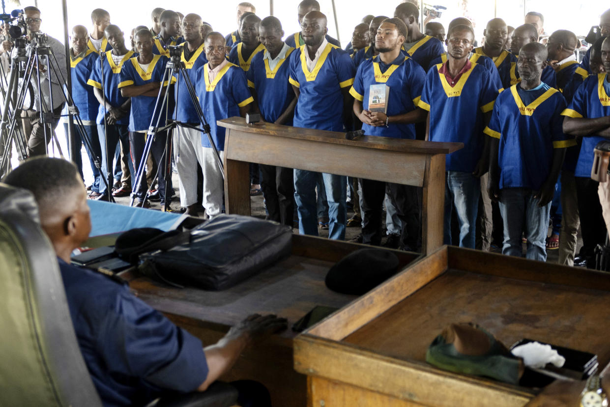 American Marcel Malanga, fourth right, stands with others during a court verdict in Congo, Kinshasa, Friday Sept .13, 2024, on charges of taking part in a coup attempt in May 2024. (AP Photo/Samy Ntumba Shambuyi)