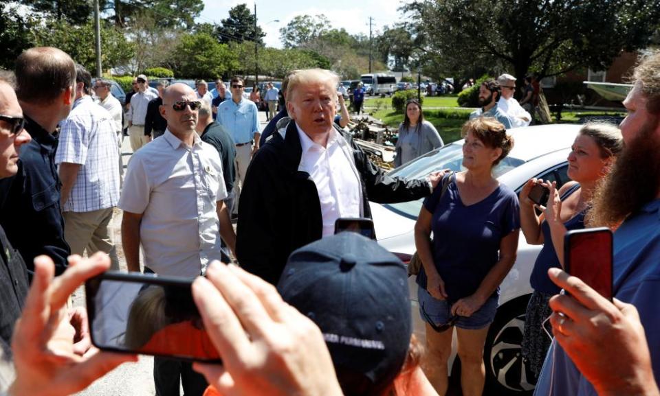 Donald Trump greets residents while on a tour of Hurricane Florence recovery efforts in New Bern, North Carolina.