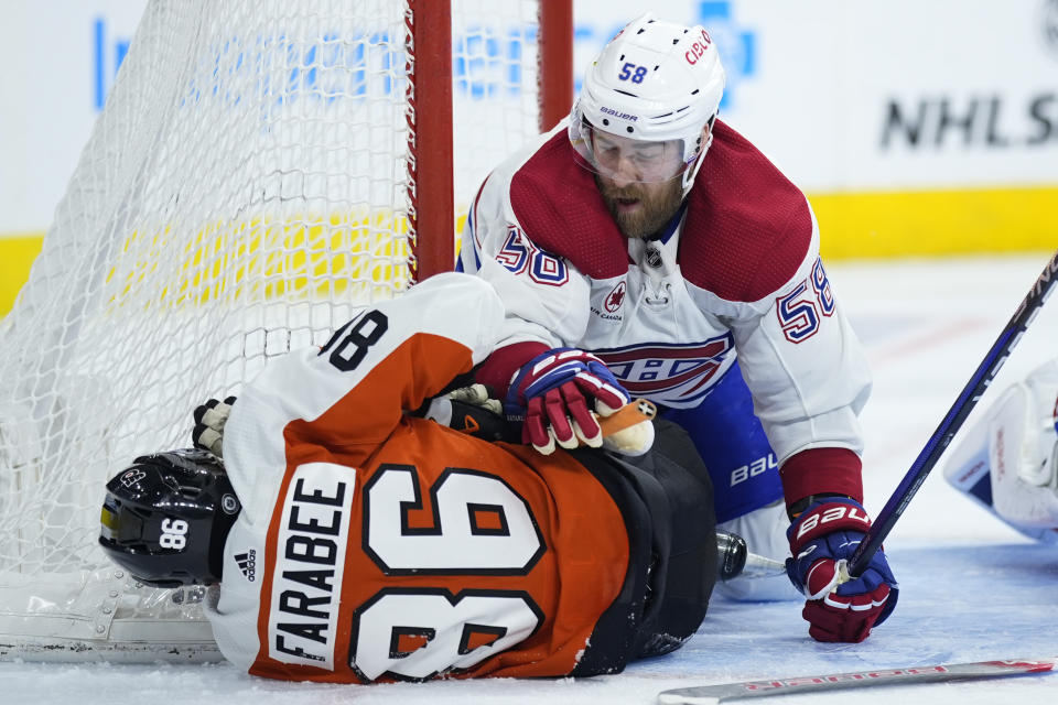 Montreal Canadiens' David Savard (58) and Philadelphia Flyers' Joel Farabee (86) collide during the second period of an NHL hockey game, Wednesday, Jan. 10, 2024, in Philadelphia. (AP Photo/Matt Slocum)