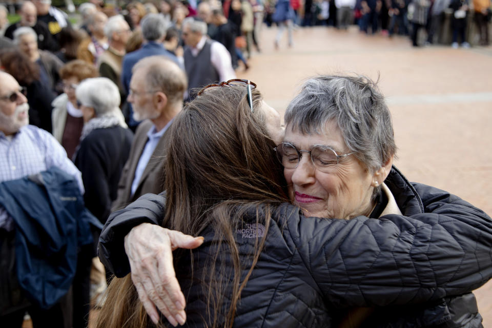 Laura Fehl, left, hugs Esther Nathanson as they arrive for the one-year commemoration of the Tree of Life synagogue attack at Soldiers & Sailors Memorial Hall and Museum, Sunday, Oct. 27, 2019, in Pittsburgh. A year ago, a gunman entered the Tree of Life synagogue and killed 11 members of three congregations, Dor Hadash, New Light and Tree of Life/Or L'Simcha, holding Shabbat services in the building. The women are long-time friends from Temple Sinai synagogue. (AP Photo/Rebecca Droke)