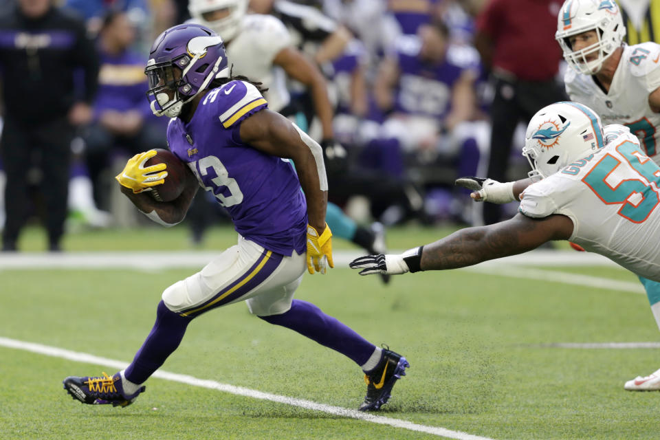 Minnesota Vikings running back Dalvin Cook (33) runs from Miami Dolphins outside linebacker Jerome Baker during the first half of an NFL football game, Sunday, Dec. 16, 2018, in Minneapolis. (AP Photo/Andy Clayton-King)