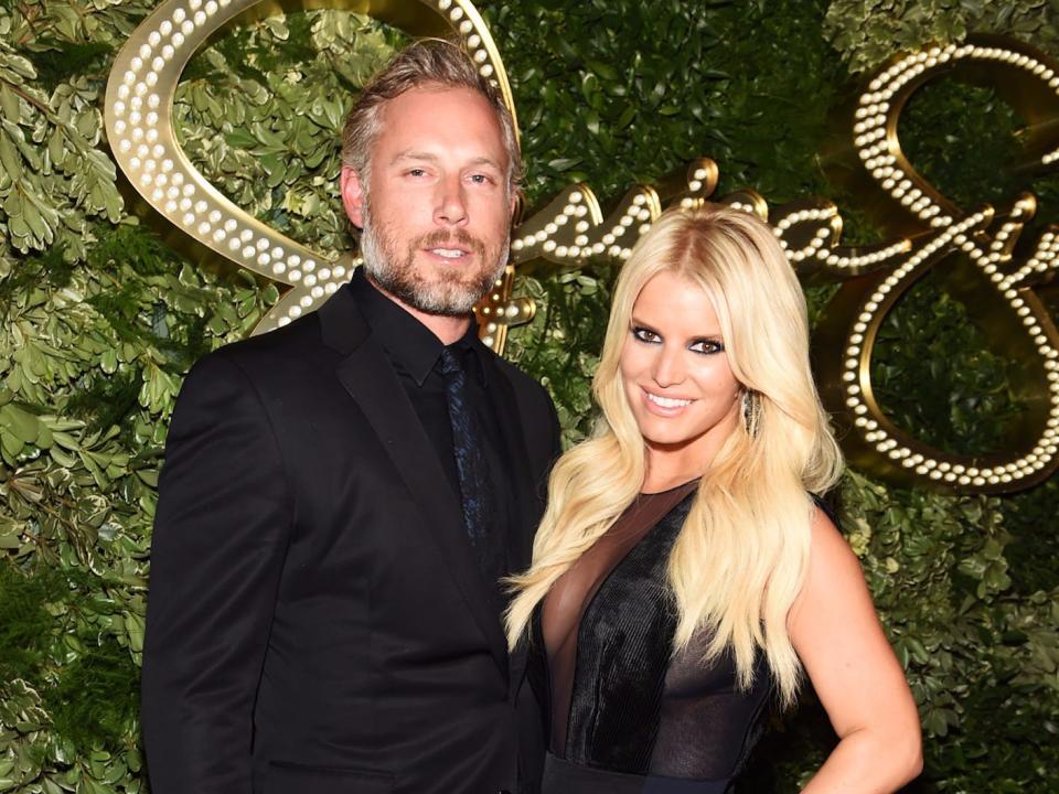 Eric Johnson and Jessica Simpson pose at an event