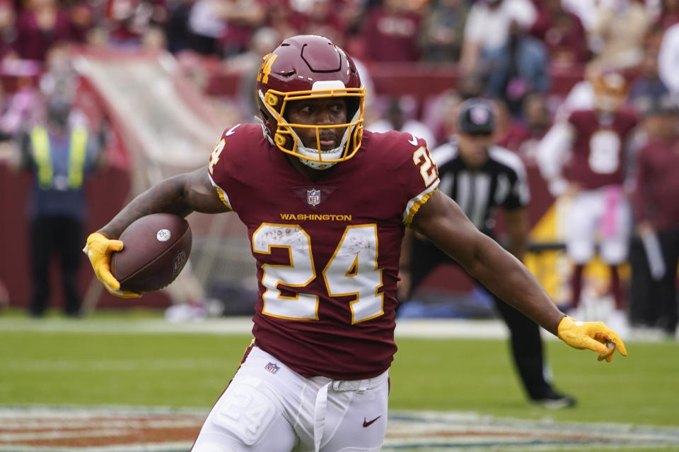 Washington Football Team running back Antonio Gibson rushes the ball in the first half of an NFL football game against the New Orleans Saints, Sunday, Oct. 10, 2021, in Landover, Md. (AP Photo/Al Drago)