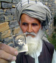 Bakhtar Gul, the father of Khiali Gul who is currently incarcerated at Guantanamo Bay, holds a photograph of him at his home in Yaqubi, about 140 kilometres (87 miles) south east of Kabul on May 13, 2004. Human Rights Watch has catalogued mistreatment of Afghan detainees it describes as "systematic" and is demanding that the results of an inquiry into two deaths be released. Photograph taken on May 13, 2004. (REUTERS/Stringer)