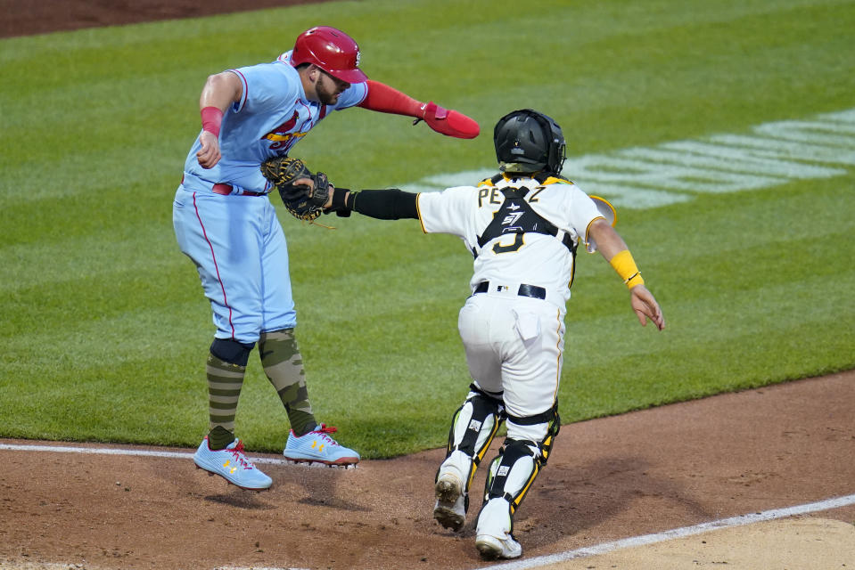 St. Louis Cardinals' Juan Yepez, left, is tagged out by Pittsburgh Pirates catcher Michael Perez (5) as he attempts to score on a fielder's choice hit into by Yadier Molina during the fifth inning of a baseball game in Pittsburgh, Saturday, May 21, 2022. (AP Photo/Gene J. Puskar)