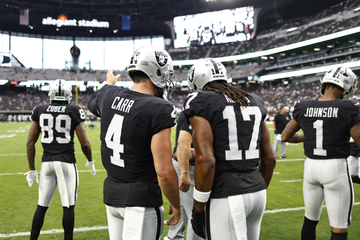 LAS VEGAS, NEVADA - AUGUST 14: Derek Carr #4 of the Las Vegas Raiders and Davante Adams #17 of the Las Vegas Raiders chat prior to a preseason game against the Minnesota Vikings at Allegiant Stadium on August 14, 2022 in Las Vegas, Nevada. (Photo by Michael Owens/Getty Images)