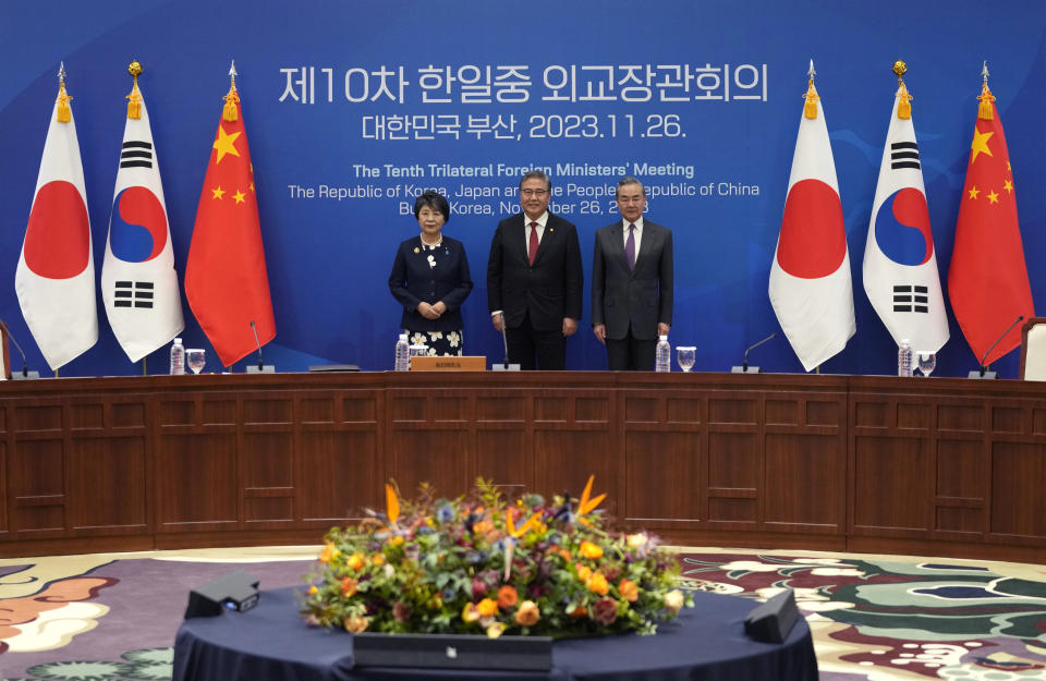 Chinese Foreign Minister Wang Yi, right, South Korean Foreign Minister Park Jin, center, and Japanese Foreign Minister Yoko Kamikawa pose for a photo prior to the trilateral foreign ministers' meeting in Busan, South Korea, Sunday, Nov. 26, 2023.(AP Photo/Ahn Young-joon, Pool)