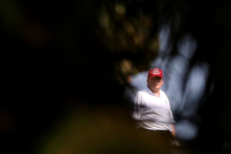Former U.S. President Donald Trump looks on at the Trump International Golf Club in West Palm Beach