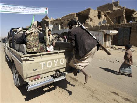 A follower of Yemen's Shi'ite Houthi group tries to climb into a car belonging to the group on the side of a road leading to the northwestern province of Saada January 23, 2013. REUTERS/Mohamed al-Sayaghi