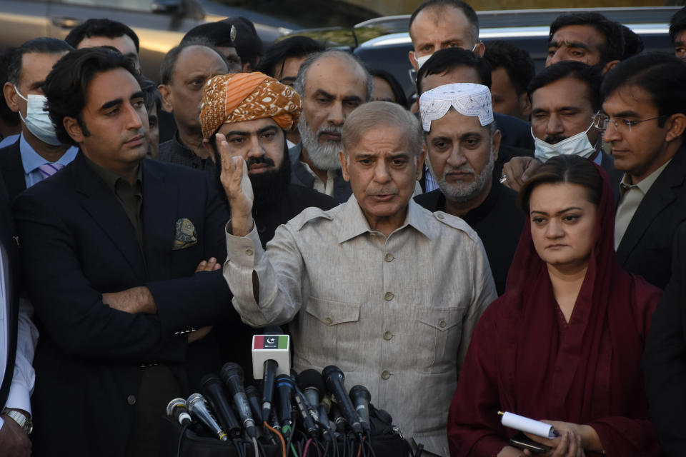 Pakistan's opposition leader Shahbaz Sharif, center, speaks to reporters while other opposition leaders watch outside the National Assembly, in Islamabad, Pakistan, Thursday, March 31, 2022. Pakistan's parliament on Thursday adjourned a debate on the political survival of Prime Minister Imran Khan after the opposition had called for a no-confidence vote on the embattled premier. (AP Photo)