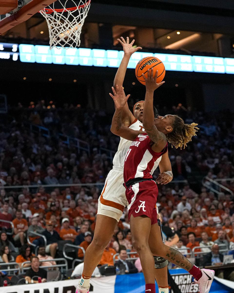 Texas forward Aaliyah Moore blocks the shot of Alabama guard Del'Janae Williams in Sunday's 65-54 win in the second round of the NCAA Tournament at Moody Center. The Longhorns used their superior size advantage to block 11 shots.