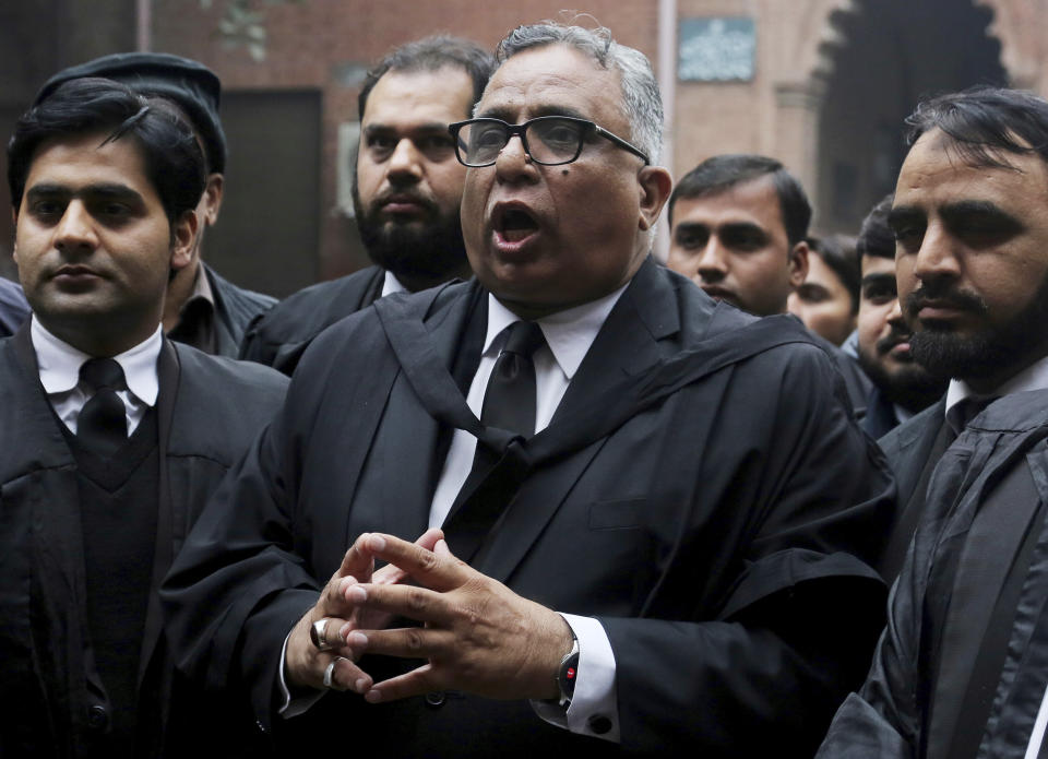 Mohammad Azhar Siddique, center, a lawyer for former Pakistani President and military ruler Pervez Musharraf, talks to journalists after a court decision, in Lahore, Pakistan, Monday, Jan. 13, 2020. The Pakistani court Monday overturned death sentence given to the country's ailing former dictator, saying a special court that last month convicted and sentenced Musharraf had been formed in violation of the law. (AP Photo/K.M. Chaudary)