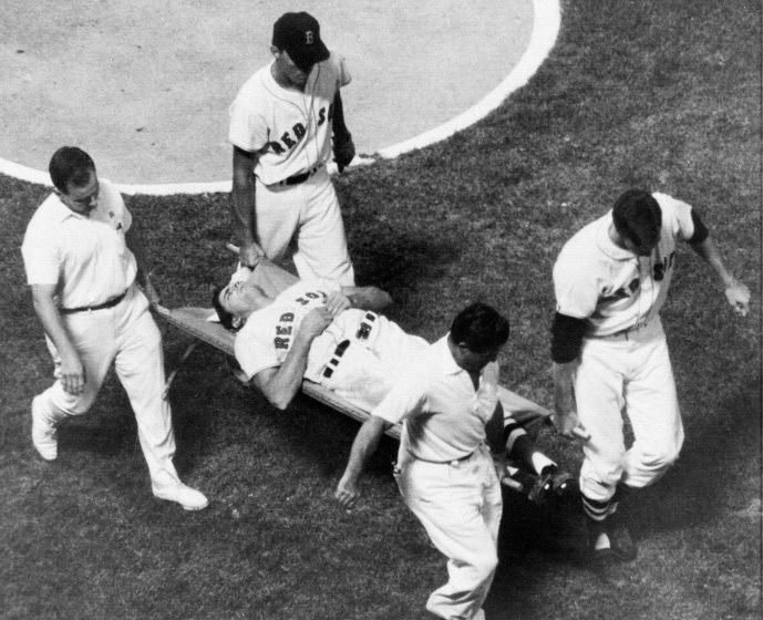 Boston Red Sox outfielder Tony Conigliaro is carried off the field on a stretcher by teammates and the trainers of both the Red Sox and the California Angels after he was beaned by Angels pitcher Jack Hamilton in the fourth inning of their game at Fenway Park in Boston, Mass., Aug. 18, 1967. The star player has been hospitalized with a severe concussion and eye injury. (AP Photo/Bill Chaplis)