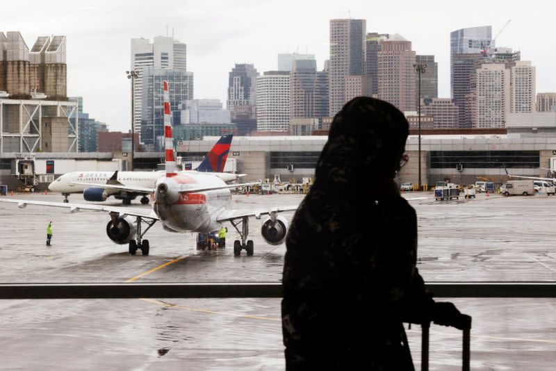 FILE PHOTO: Passengers travel through Logan Airport in Boston