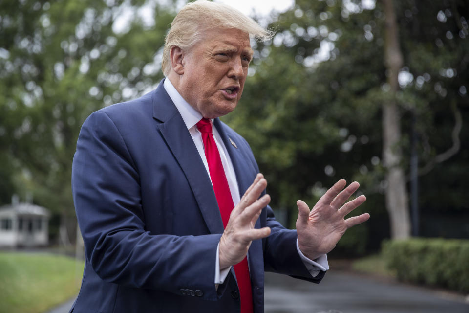 President Donald Trump speaks with reporters as he walks to Marine One on the South Lawn of the White House, Friday, July 31, 2020, in Washington. Trump is en route to Florida. (AP Photo/Alex Brandon)