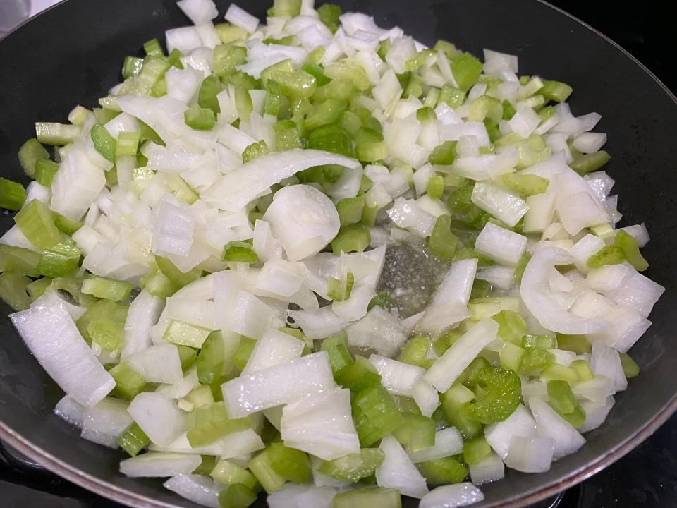 Celery and onion cooking in pan for Paula Deen's stuffing