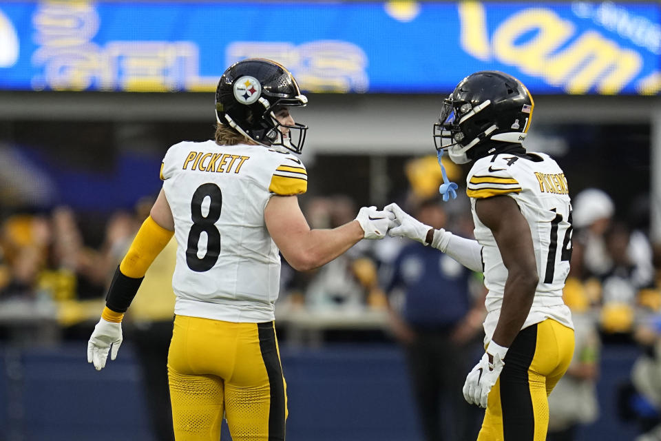 Pittsburgh Steelers quarterback Kenny Pickett, left, congratulates wide receiver George Pickens after Pickens made a catch during the second half of an NFL football game against the Los Angeles Rams Sunday, Oct. 22, 2023, in Inglewood, Calif. (AP Photo/Gregory Bull)