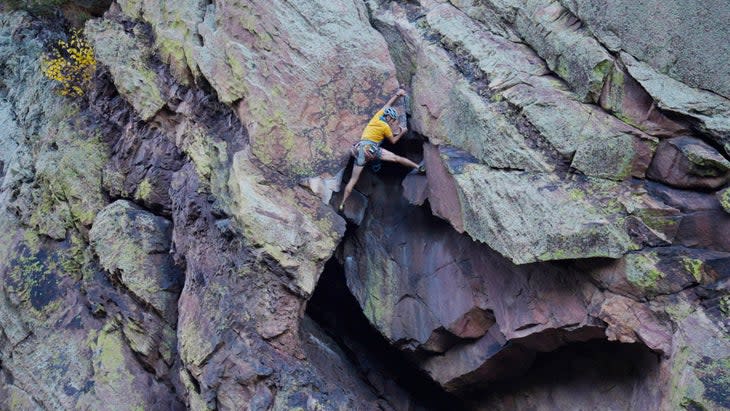 Rock climber on Naked Edge rock climb in Eldorado Springs Canyon, Colorado.